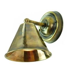 an antique brass wall light on a white background