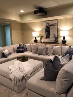 a living room filled with lots of couches and pillows on top of each other