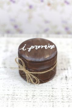 a small wooden box with the word i surprise written on it sitting on a table