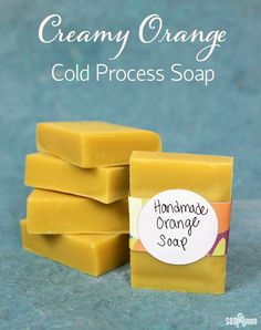 soap bars stacked on top of each other with the words, creamy orange cold process soap