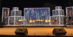 an outdoor stage set up with speakers and lights