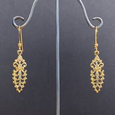 Here is a lovely pair of dainty ornate floral dangle earrings. These were actually made in the early seventies. They are good quality, new (unused) vintage items, made of gold plated brass. 9mm wide x 45mm high (with earwire) BOY66 IMPORTANT: please note that I offer different earwires as seen in second picture, and the price of the earrings vary depending on the chosen earwires.  It goes as follows: A: gold plated base metal french wires with ball (rubber stoppers included).  B: gold plated bas Formal Filigree Baroque Earrings, Formal Baroque Filigree Earrings, Antique Gold Chandelier Earrings, Ornate Yellow Gold Chandelier Drop Earrings, Gold Baroque Victorian Earrings, Gold Victorian Baroque Earrings, Gold Filigree Drop Flower Earrings, Vintage Yellow Gold Dangle Earrings, Vintage Gold Teardrop Plug Earrings