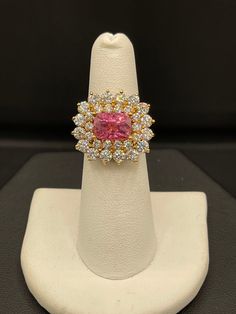 This is a beautiful and very rare Pamir Spinel and Diamond 18K yellow gold statement ring. The Spinel is very rare as it is a single source gem that is only mined for about two months a year due to the climate in the Pamir mountains in Tajikistan, the second highest mountain range in the world. The same company that mines this Spinel, facets it to the highest standards therefore they never have bellys or windows and have the most return of light. This clean cushion cut Spinel has a neon orangy p Luxury Gia Certified Yellow Gold Cluster Ring, Gia Certified Gold Sapphire Ring In 14k Gold, Luxury Gia Certified Cluster Ring In Yellow Gold, Gia Certified Gold Cluster Jewelry, Luxury Gia Certified Yellow Gold Sapphire Ring, Luxury Yellow Gold Gia-certified Sapphire Ring, Gia Certified Oval Gold Sapphire Ring, Exquisite Formal Yellow Gold Cluster Ring, Exquisite Yellow Gold Cluster Ring For Formal Occasions