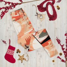 an assortment of christmas items including stockings, mittens and other holiday decorations on a white wooden background