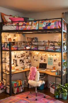 a loft bed with a desk underneath it and lots of clutter on the shelves