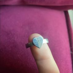 Sterling Silver Gucci Heart Ring. Never Worn. I Am Trying To Get Rid Of All My Gucci Clothes And Jewelry. Although Very Comfy And Stylish I’ve Spent Too Much On All Of It. Trying To Make Some Money So I Can Restart My Shoe Collection. Comes With Box. Will Trade For Other Shoes But Not Other Rings. Crafted From 925 Sterling Silver, The Heart Detail Defines This Love Ring, A Jewelry Piece Reflecting The House's Romantic Narrative. The Gucci Trademark Further Enhances The Accessory. Gucci Sterling Silver Jewelry With Heart Charm, Gucci Sterling Silver Ring, Elegant Gucci Jewelry With Heart Charm, Gucci Jewelry With Heart Charm, Gucci Jewelry With Heart Charm As A Gift, Gucci White Gold Sterling Silver Ring, Classic Gucci Sterling Silver Rings, Gucci Jewelry For Valentine's Day Anniversary, Gucci Elegant Heart Charm Jewelry