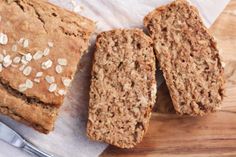 three pieces of bread sitting on top of a wooden cutting board