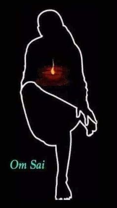 the silhouette of a person sitting in front of a lit candle on a black background