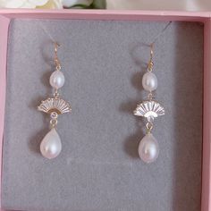 * DETAILS * -  Natural Freshwater Teardrop Baroque Pearls - 18K gold plated on brass Fan Shape Charms size 14mm - Gold Plated earring hooks   🎁 These earrings come in a special designer pouch enclosed in a cardboard box. A designer pull drawer pink gift box is available when the gift wrapping option is chosen. 👉🏻For more earrings, see https://www.etsy.com/shop/JinnysJewelryBySeJin 🌟matching necklace. https://www.etsy.com/JinnysJewelryBySeJin/listing/1177137497/14k-gold-filled-lariat-necklace Gold Plated Teardrop Earrings For Celebration, Yellow Gold Brass Earrings For Wedding, Gold Round Bridal Earrings With Ear Wire, Yellow Gold Plated Earrings For Weddings, Delicate Gold Bridal Earrings, Gold Plated Bridal Earrings For Wedding, Brass Earrings For Wedding, Gold Plated Teardrop Pearl Earrings For Anniversary, Gold Round Clip-on Earrings For Wedding