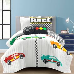 a child's bed with race cars on the comforter and matching pillow cases