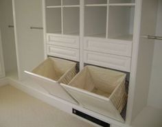 two bins in the middle of a closet with white walls and carpeted floor