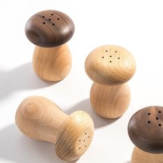 three wooden pegs with holes in them sitting next to each other on a white surface