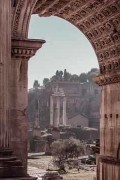 the ruins of ancient rome are seen through an archway