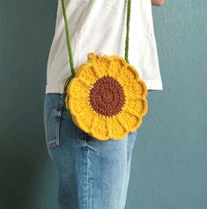 Crafted with eco-friendly yarn, this stylish crossbody bag features an adorable yellow lion design, making it both a fun and practical accessory.  Perfect for those who love unique, handmade items that are also environmentally conscious, this bag is great for casual outings or as a thoughtful gift for friends and family. The high-quality yarn ensures durability, while the crochet technique adds a cozy, handmade touch.  Surprise someone special with this cute and fashionable eco-friendly accessory! Crochet Yellow, Eco Friendly Accessories, Yellow Handbag, Lion Design, Environmentally Conscious, Gift For Kids, Crochet Techniques, Handmade Crochet, Cross Body Handbags