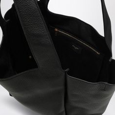 Imagine strolling through the city streets with an effortlessly chic companion by your side. This tote is a perfect blend of style and practicality, crafted for those who carry their world with them in elegance. It's not just a bag—it's a statement of timeless fashion with a relaxed vibe. Crafted from luxurious black leather Features a tab and hook-and-eye fastening for secure closure Includes a main compartment and an interlaced zipped pocket for organization Made in Italy with impeccable craft Leather Tote Bag Women, Black Leather Tote Bag, Black Leather Tote, Logo A, Louis Vuitton Shoulder Bag, Black Tote Bag, Bag Women, Chanel Handbags, Leather Tote Bag