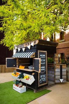 an outdoor stand with fruits and vegetables for sale