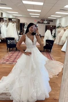 a woman taking a selfie in a wedding dress