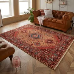 a living room filled with furniture and a large rug