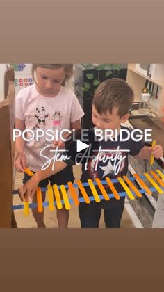 two young boys standing next to each other with popsicle bridge on top of them