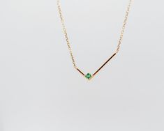 This minimalist solid gold necklace features a simple geometric L shape gold bar with a single square shape emerald, for an asymmetrical look that's both simple and strikingly graphic. The piece looks equally good worn alone or stacked with other styles.details: 18k yellow gold the square shape emerald is measured 2mm x 2mm the L shape is measured 8mm x 16.5mm 18” length with 2” extender spring-ring closure One piece in 18k yellow gold in stock, ready to ship! Gold Emerald Necklace For Formal Occasions, Gold Emerald Necklace For Formal Events, Minimalist Emerald Necklace For Formal Occasions, Minimalist 14k Yellow Gold Emerald Necklace, Minimalist Formal Emerald Necklace, Formal Minimalist Emerald Necklace, Minimalist Gold Emerald Necklace, Minimalist Rectangular Emerald Jewelry, Minimalist Yellow Gold Emerald Necklace