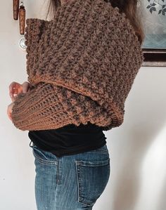 the woman is wearing a brown knitted shawl