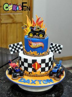 a birthday cake with monster trucks on it