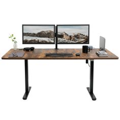 two computer monitors sitting on top of a wooden desk next to a keyboard and mouse