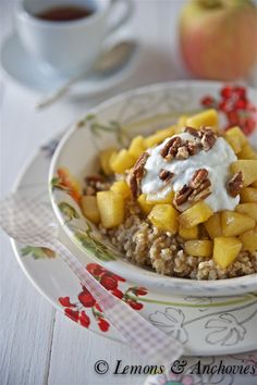 a bowl filled with oatmeal and fruit on top of a table