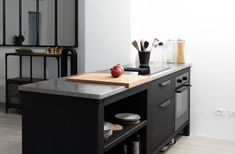 a kitchen island with an apple on top in front of a mirror and other items