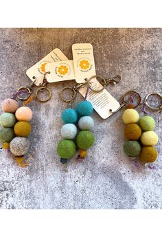 several different colored balls and keychains are on the ground next to each other