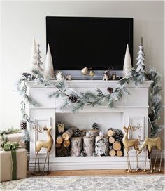 a living room decorated for christmas with deers and pine cones on the mantel