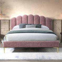 a bed with pink upholstered headboard and foot board on top of it