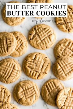 twelve peanut butter cookies laid out on a marble surface