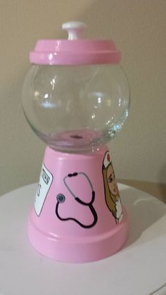 a pink gummy machine with a stethoscope on it's top