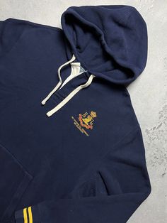 Polo Ralph Lauren 1st Division Logo Vintage Hoodie y2k 90s Size Men's / US XL / EU 56 / 4 Color Navy Condition Gently Used Vintage 2000s/Early 2010s Polo Ralph Lauren 1st Division RL Regiment 381 Blecker Hoodie Has rugby style collar and buttons The material is pleasant to the body. In a good condition. Fast sending! Condition : 8,7/10 Chest - 66 cm Length - 70 cm Shoulders - 55 cm Sleeve Length - 65 cm - ALL ITEMS ARE HEAT TREATED AND WASHED BEFORE SHIPPING - FOLLOW MY STORE - SEE MY OTHER ITEM Navy Sporty Hoodie With Embroidered Logo, Sports Hooded Top With Embroidered Logo, Navy Sweatshirt With Kangaroo Pocket For Streetwear, Navy Hoodie With Embroidered Logo For Fall, Navy Casual Hoodie With Embroidered Logo, Vintage Hoodie With Kangaroo Pocket, Vintage Long Sleeve Hoodie With Kangaroo Pocket, Navy Embroidered Logo Hooded Sweatshirt, Navy Hooded Sweatshirt With Embroidered Logo