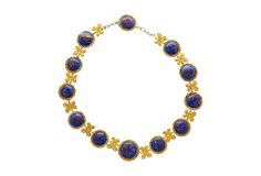 Lapis Necklace in 14k & 18K Gold.  This Riviera-styled necklace features 12 cabochon-cut lapis gemstones, each measuring 19-16 mm, and exhibits gold detailing within each stone, enhancing the royal blue hue. The necklace is crafted from 14K & 18K yellow gold, and surround each lapis stone with a textured design. The gold is also crafted into paisley art nouvea design between each stone, adding a feel of historical elegance to the piece. Comfortably sized at 17 inches and weighing 71.02 grams, th Riviere Necklace, Lapis Stone, Lapis Necklace, Paisley Art, Textured Design, Blue Lapis, Metal Necklaces, Personalized Necklace, Gold Details