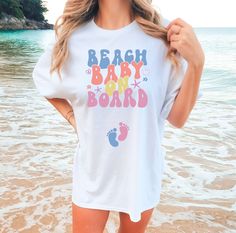 Sun, sand, and a little surprise: our Beach Baby On Board tee makes the perfect pregnancy reveal! 🌊👶 White Family Matching T-shirt For Beach, White Casual Maternity T-shirt, Family Matching White T-shirt For Beach, White Letter Print T-shirt For Gender Reveal, Cute White T-shirt For Gender Reveal, Family Matching White Maternity T-shirt, White Family Matching Maternity T-shirt, White Graphic Maternity T-shirt, Bump Friendly White Short Sleeve T-shirt