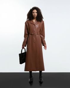 A brown faux leather long coat. Has wide padded shoulders.. The shoulders/sleeves are over sewn. Bat-style sleeves. Button and belt fastening.• Material – faux leatherMeasurements:XS - Bust(cm):80-82; Waist(cm):63-64; Hips(cm):87-89.S - Bust(cm):83-84; Waist(cm):65-66; Hips(cm):90-92.M - Bust(cm):88-90; Waist(cm):68-70; Hips(cm):94-96.L - Bust(cm):92-94; Waist(cm):74-76; Hips(cm):98-100.XL - Bust(cm):96-98; Waist(cm):78-80; Hips(cm):102-104.Those who are between sizes should order the larger siz Luxury Brown Belted Outerwear, Belted Brown Outerwear For Business, Brown Double-breasted Outerwear With Belted Cuffs, Brown Belted Cuffs Office Outerwear, Brown Faux Leather Outerwear For Office, Formal Brown Faux Leather Outerwear, Brown Belted Leather Jacket With Long Sleeves, Brown Double-breasted Leather Jacket For Work, Double-breasted Brown Leather Jacket For Work