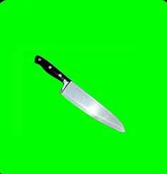 a large knife with a black handle on a green background