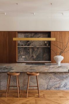 two stools sit in front of a marble counter top