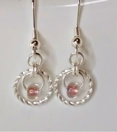 "Classic and beautiful, these chain maille earrings feature just a touch of color. Perfect for casual wear or dressing up!  Earrings are made with silver-plate components and glass beads. Fish hook ear wires finish the look.  1.25\" long These earrings can also be custom ordered for any special occasion. Looking for a set in the same color to match your bridesmaid's dresses or need a specific color to match your party dress? Let me know and I can make one or more pairs specifically for you!" Cheap Nickel-free Beaded Drop Earrings, Cheap Silver Earrings With Colorful Beads, Cheap Glass Earrings With Dangling Beads, Silver Round Wire Wrapped Beaded Earrings, Round Silver Wire Wrapped Beaded Earrings, Diy Earrings Dangle, Beaded Teardrop Earrings, Diy Wire Jewelry Rings, Rings Art Deco