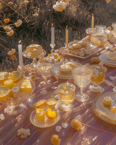 the table is set with yellow dishes and candles