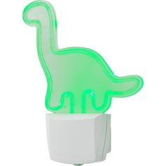 a green dinosaur shaped light sitting on top of a white wall