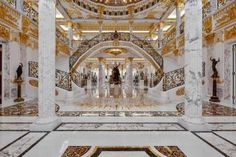 the interior of a building with gold and white decorations