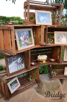 an arrangement of wooden crates with pictures and photos on the shelves, all stacked together