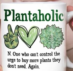 a person holding up a coffee mug with plants and peace signs on the inside, in front of them