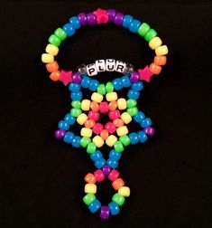 a colorful beaded bracelet with the word plur on it