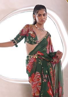 Step into effortless grace with this Green Floral Printed Pre-Draped Saree Set—your go-to for a standout Mehendi look. This ready to wear saree combines chic convenience with traditional charm, adorned with intricate embroidery. Perfectly paired with an embroidered blouse and stylish belt, it's an epitome of elegance for the modern woman. Composition : Saree, Blouse and Belt - Georgette Care: Dry Clean Only and Vacuum Storage This product can be customized for sleeves, length of blouse and neckline Delivery : 4-6 weeks as the product is hand crafted. Check Size Guide or choose MySize for free customisation (All Sizes above XL can be made at 15% additional cost) For more information and sizes please contact fabiliciousfashion@gmail.com or visit our Copenhagen studio. About the Designer : Ma