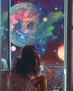 a woman sitting on a balcony looking out at the stars and planets in the sky