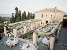 an outdoor venue with tables and chairs set up for a formal function in front of the ocean